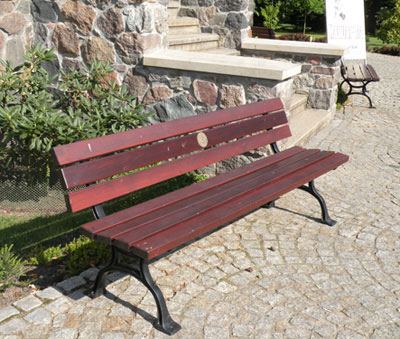 widok ławki z tabliczką mosiężną.